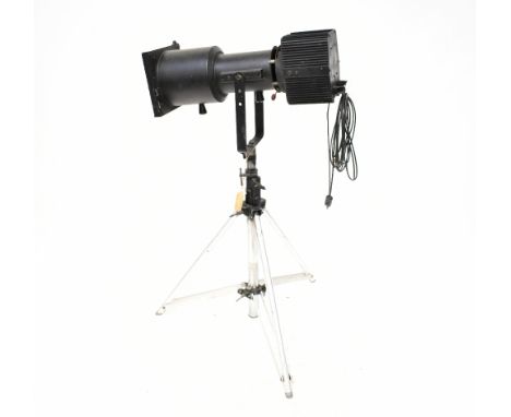 A vintage black painted theatre spotlight mounted on a telescopic tripod, height 139cm. CONDITION REPORT Overall solid, but w