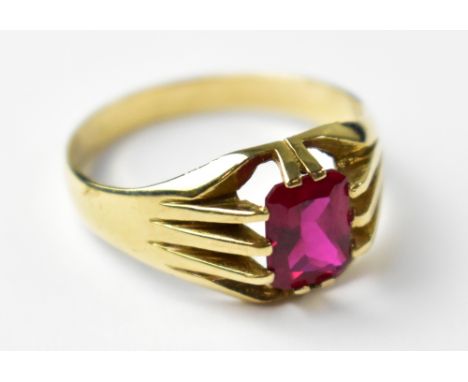 A gentlemen's 9ct yellow gold dress ring with central emerald cut ruby, size S, approx 3.9g.