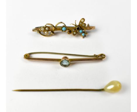 A 9ct gold bar brooch with seed pearl and turquoise flowers and a seed pearl and turquoise gold butterfly applied to the bar,