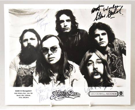 STEELY DAN; a black and white promotional photograph bearing the five band members' signatures, 20.5 x 25cm.We have not authe