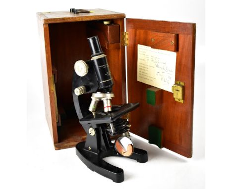 A vintage Cooke, Troughton &amp; Simms Ltd York, England microscope with black lacquered body and adjustable table, various l