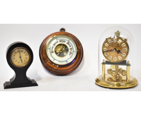 A small desk clock of balloon shape, the ebonised wooden body with barrel movement, height 13cm, a modern anniversary clock u