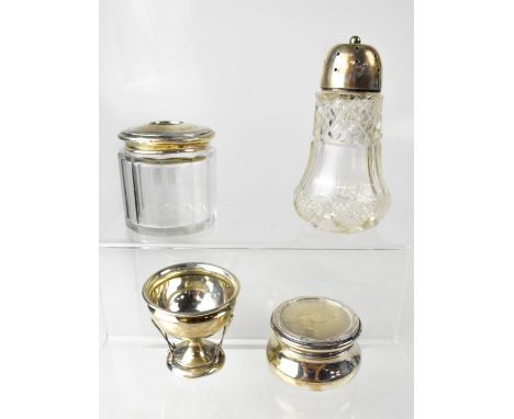 Two cut glass dressing table pots with hallmarked silver tops, marks rubbed, a hallmarked silver golfing trophy, with decorat