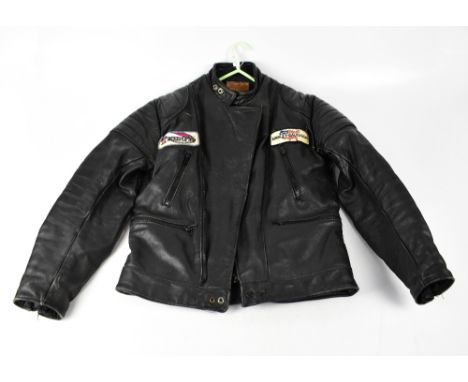 A vintage black leather 'Dominator' bomber jacket with fabric badges for 'Triumph' and 'Harley Davidson', chest size 42".