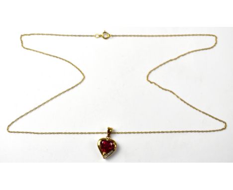 A 9ct gold heart-shaped pendant with claw set centred heart-shaped ruby and a row of four tiny diamonds to the bottom edge, o
