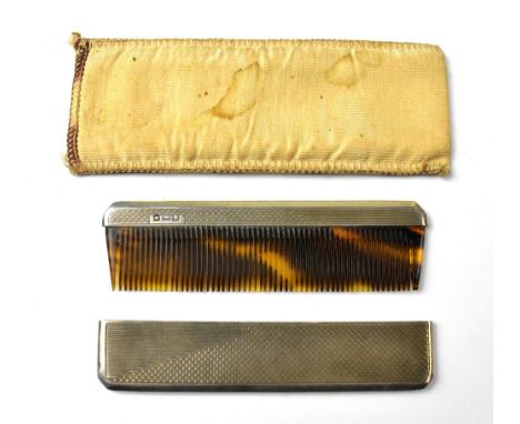 A George V hallmarked silver backed travelling comb the case with engine turned decoration, within a cloth slip case, length 