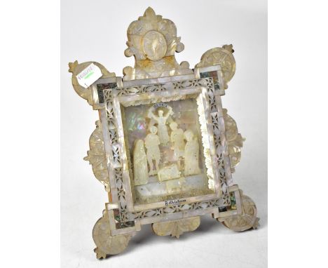 A Jerusalem mother of pearl picture depicting the nativity scene titled 'Gloria Bethlehem', within a pierced border with inla