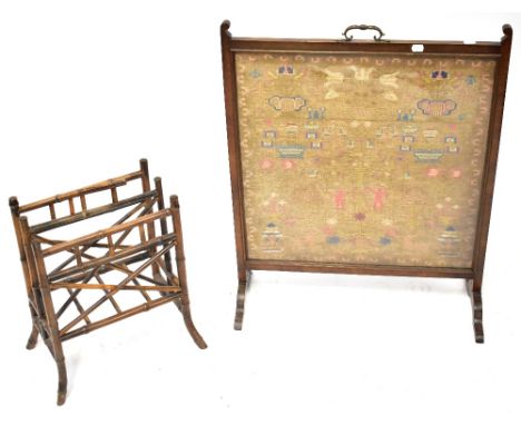 A 19th century mahogany framed fire screen inset with a needlework panel depicting Adam and Eve under the tree, the Serpent c