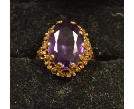 A 9ct gold ring set with a large amethyst, hallmarked