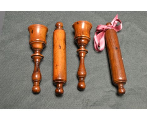 A mid 19th century treen miniature rolling pin, 14.5cm long;  another, similar;  a turned pestle;  etc (4)