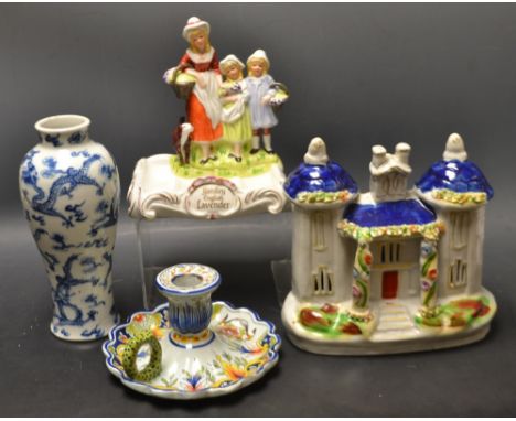 A French faience chamber stick, Rouen crest; a Yardley soap dish; a Staffordshire cottage; a Chinese blue and white vase (4)