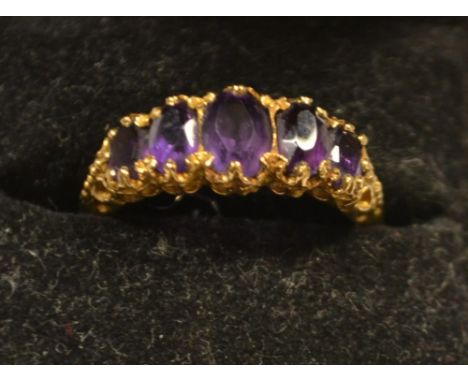 A 9ct gold ring set with a small amethyst, hallmarked
