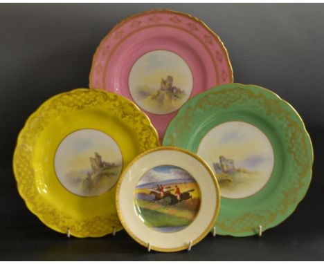 A set of three Royal Worcester shaped circular plates, painted with castle ruins, bordered in green, pink and yellow, printed
