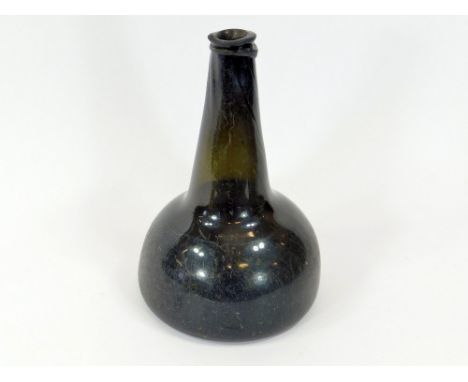 SALVAGED WINE BOTTLE. A dark green salvaged 18th century squat mallet shape bottle recovered from the wreck of the H.M.S. Ass