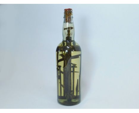 GOD-IN-A-BOTTLE. A Folk Art God-in-a Bottle, containing a group of detailed wooden miners & agricultural tools, a wooden cros