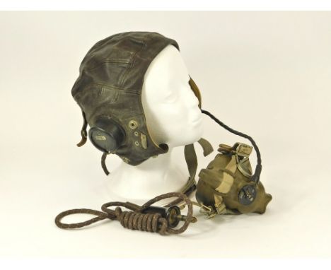 WWII FLYING HELMET. A WWII period Type C flying helmet with earphones, mask & jack plug. Size No.3. 7 1/8 -7 3/8 inches. Cond