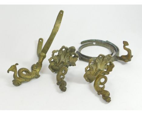 WRECK ARTEFACTS. Three stylised brass dolphin oil lamp mounts, one with its gimbal ring attached. The pair were recovered by 