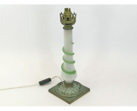 TABLE LAMP. A table lamp with opaque glass column & green spiral trailed decoration. The base in cast brass. Height 40cm. Ple