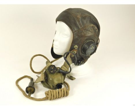 WWII FLYING HELMET. A WWII period Type C flying helmet with earphones, mask & jack plug. Size No. 4. 7½ -7 3/4 inches. Condit