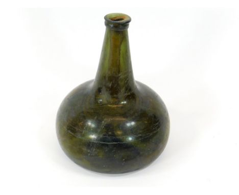 SALVAGED WINE BOTTLE. A salvaged 18th century squat mallet shape bottle, recovered from the wreck of the H.M.S. Association. 