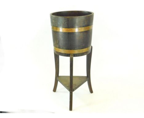 JARDINIERE. A brass bound, oak jardiniere with R. Alister & Co., Ltd., Dursley, England ivorine maker's label. Height 68cm. D