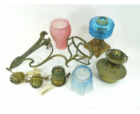 OIL LAMP ETC. An Art Nouveau gilt metal oil lamp wall bracket fitted with a brass oil lamp. Also, an oil lamp cast iron base 