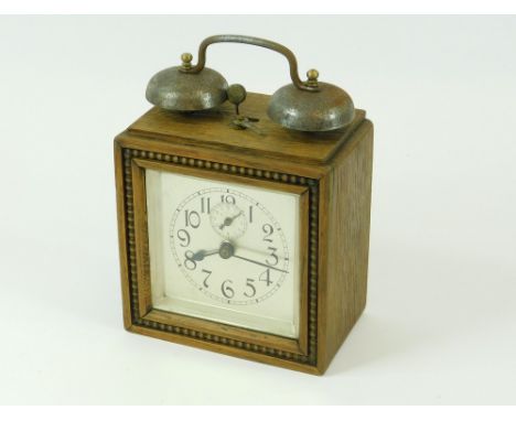 ALARM CLOCK. An Art Deco, oak cased, twin bell alarm clock. Full height including fixed handle 22cm.  All clocks in this auct