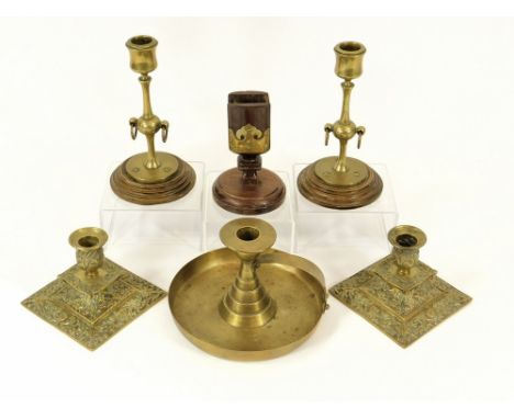 CANDLESTICKS ETC. A pair of brass candlesticks each on a turned wooden base. Height 17cm. Also, a pair of square, cast brass 