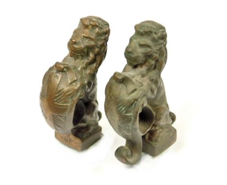 CAST BRONZE LIONS. A pair of cast bronze lion rampant, each supporting a shield, possibly furniture mounts. This pair was rec