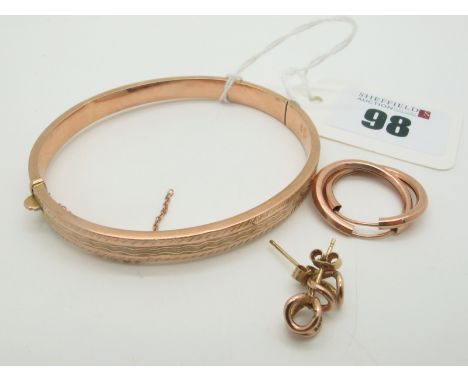 A 9ct Rose Gold Hinged Bangle, of part patterned design (dents) (7grams); Together with A Pair of Hoop Earrings, and a pair o