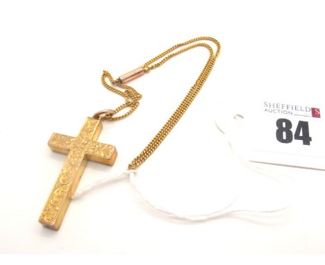 A 9ct Gold Cross Pendant, leaf scroll engraved, suspended on a short chain.Lot 84 - Overall weight 5.5 grams, chain barrel fa