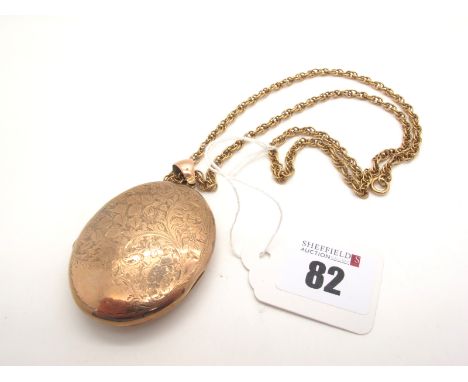 A Large Oval Locket Pendant, foliate leaf scroll engraved, stamped "9ct", on a fancy link chain. 