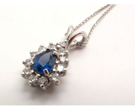 An 18ct White Gold Diamond Set Teardrop Cluster Pendant, claw set throughout, on a fine chain stamped "750". 