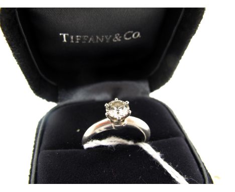 Tiffany & Co; A Modern Platinum Single Stone Diamond Ring, the brilliant cut stone claw set between plain rounded knife edge 