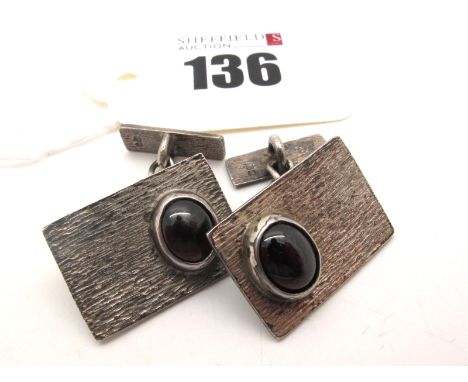 A Pair of Stylish Hallmarked Silver Cufflinks, the rectangular bark textured panels collet set with oval cabochon, on chain c
