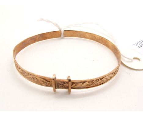 A 9ct Gold Child's Expanding Bangle, allover leaf scroll decoration (2.8grams). 