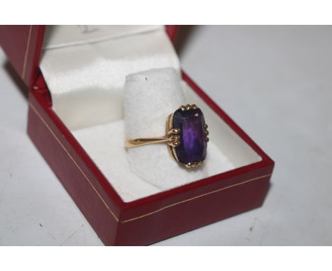 An 18ct gold ring set with large amethyst coloured stone, ring size P, approx. total weight 3.8gms