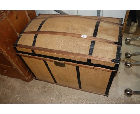 A canvas and batten dome topped travelling trunk