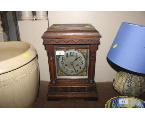 An oak cased two hole mantel clock 