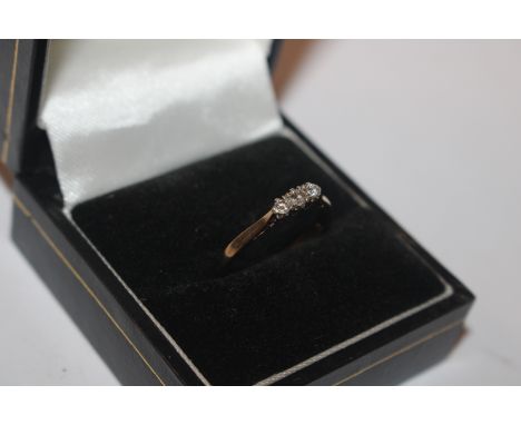 A 9ct gold ring set with three diamonds, size N/O, approx. 1.6gms 