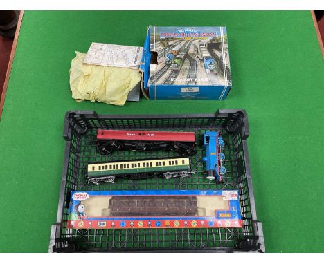 A Hornby 00 gauge Thomas the Tank Engine together with three coaches, one boxed and an Engine Shed kit, playworn and untested