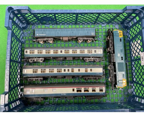 A Hornby OO gauge Hymek diesel locomotive in BR Blue together with three BR Blue Grey coaches and a Newspapers Van by Lima an