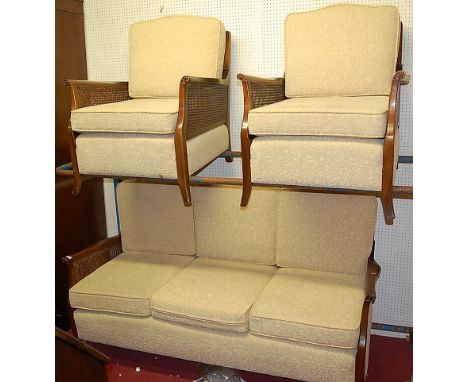 An early 20th century mahogany and double split cane three piece Bergere suite comprising; three seater sofa and a pair of ar