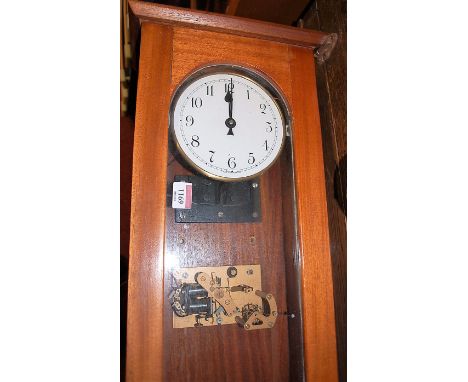 A mid-20th century electric droptrunk wall clock, with white enamel circular dial and pendulum, h.141.5cm