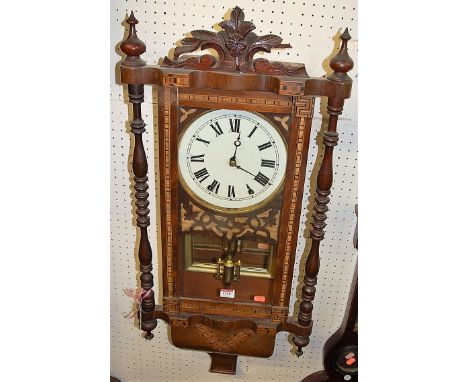 A late Victorian walnut and Tunbridge type inlaid drop trunk wall clock, having ring turned outer columns