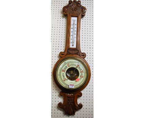 An early 20th century relief carved oak aneroid two dial wheel barometer by A Wehrle &amp; Sons, Newmarket &amp; Cambridge