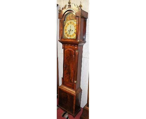 An early 19th century flame mahogany and mahogany crossbanded long case clock, having a painted arch dial, eight day movement