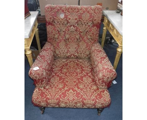 A VICTORIAN BUTTON BACK ARMCHAIR upholstered in red material