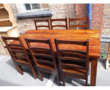 A SOLID TEAK FARMHOUSE TABLE, on square legs, 71" x 36" and six matching solid seat ladder-back chairs