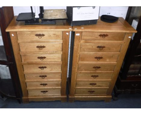 A PAIR OF CONTEMPORARY LIGHT OAK TALL CHESTS OF DRAWERS, each with seven drawers with drop ring handles, each: 51.75" high x 